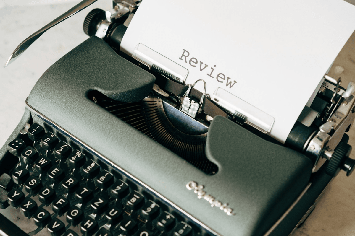 A classic typewriter with the word review on the first page.