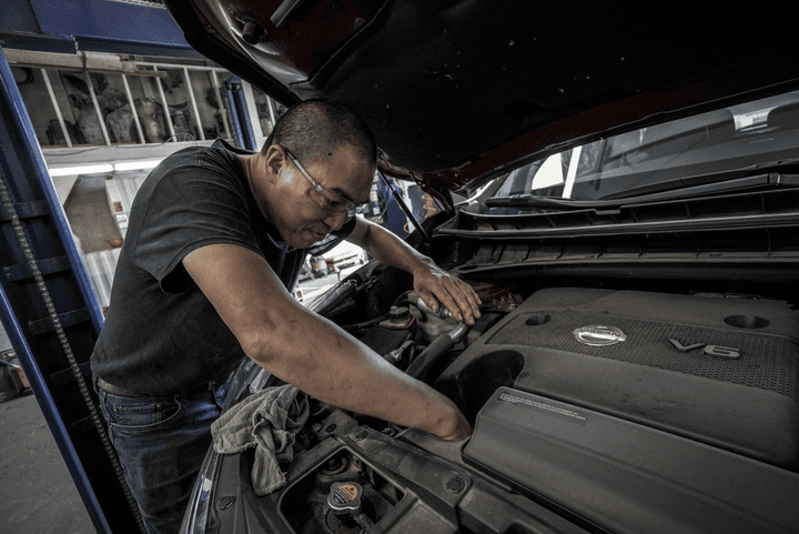 A mechanic completing vehicle maintenance.