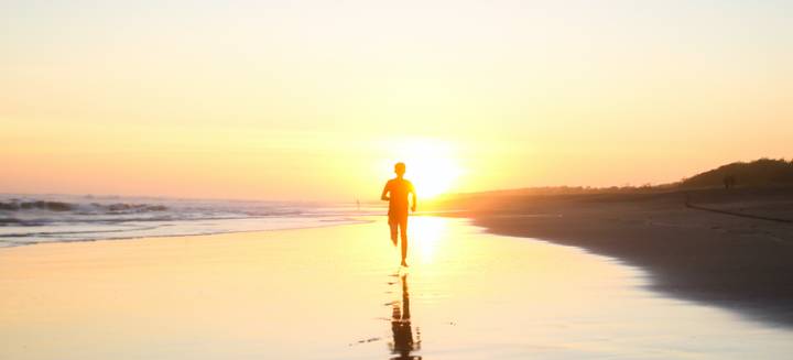 running towards sunset on the beach