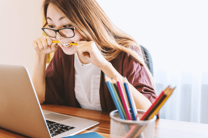 A New Zealand woman comparing insurance options on a laptop at her dining table, representing the informed decision-making process that Quashed empowers in this 2026 comparison guide.