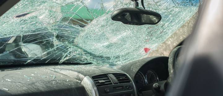 A shattered windscreen from a car accident, highlighting the importance of comprehensive car insurance in New Zealand. This image represents common claims related to glass damage and accident coverage.