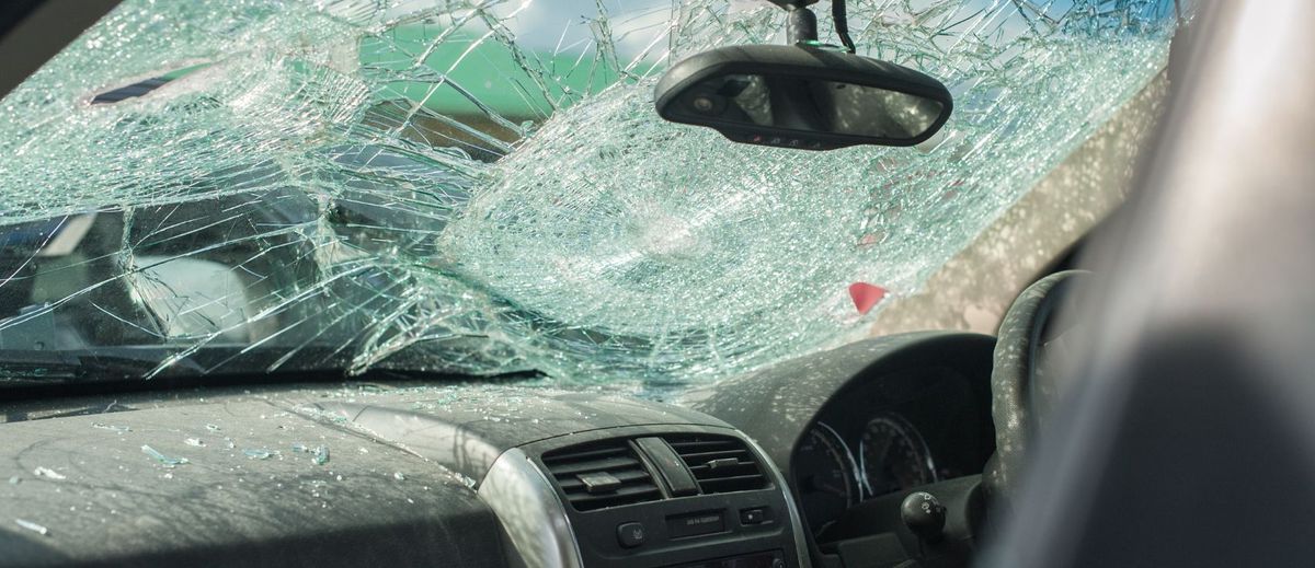 A shattered windscreen from a car accident, highlighting the importance of comprehensive car insurance in New Zealand. This image represents common claims related to glass damage and accident coverage.