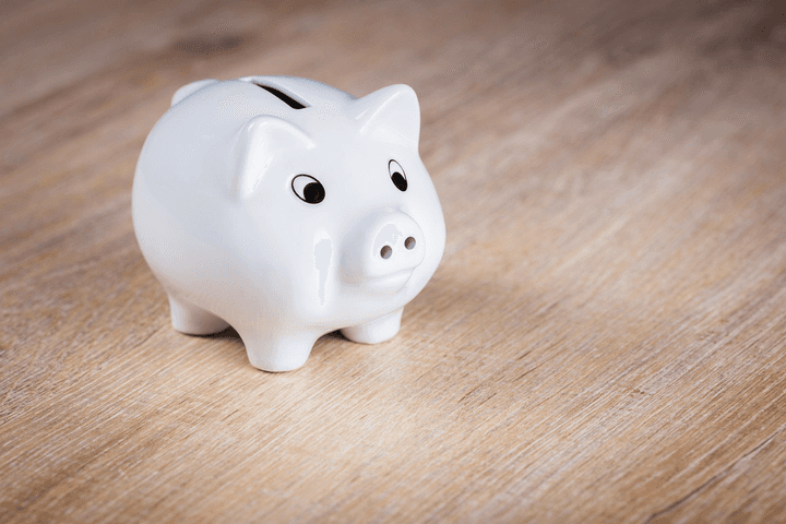A white piggy bank symbolizing potential savings on New Zealand home insurance premiums and avoiding the loyalty tax with Quashed in 2026