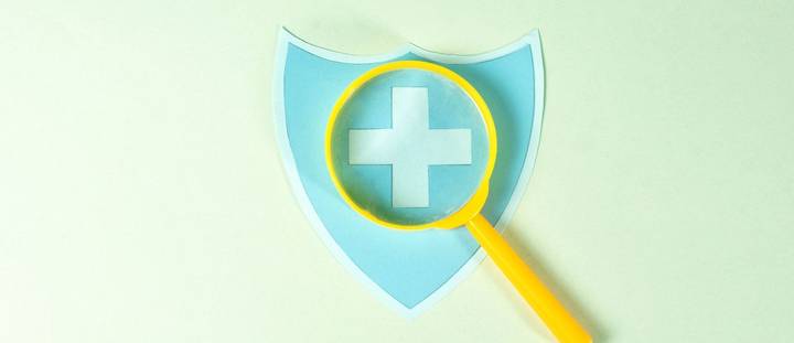 A medical icon under a magnifying glass.