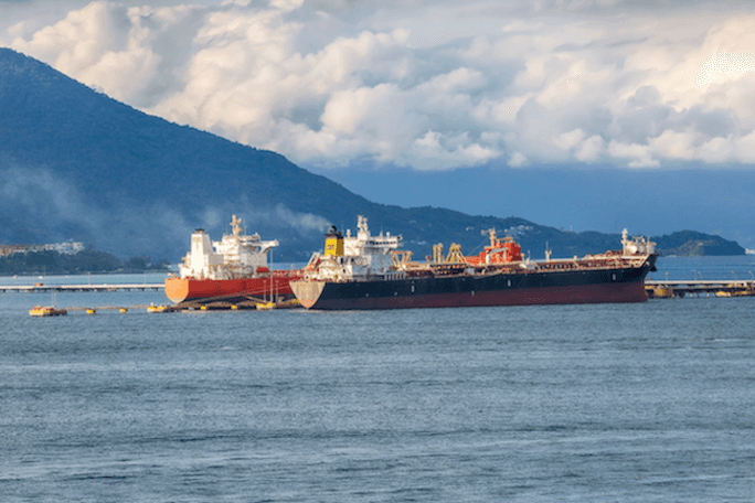 Ships transporting oil, representing the disruption to oil supply through the Strait of Hormuz that is driving New Zealand petrol prices to record highs in 2026.