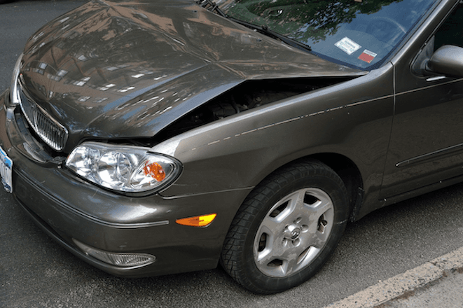 A close-up of a damaged car hood.