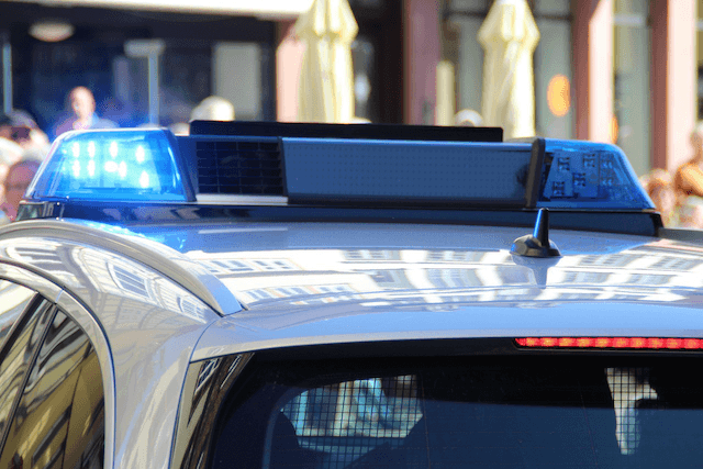 A New Zealand police vehicle with lights on.