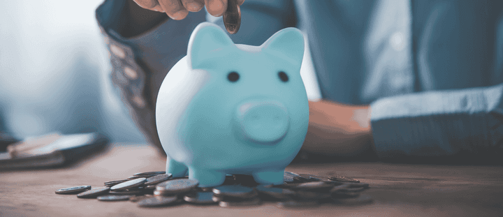 A blue piggy bank on a table.